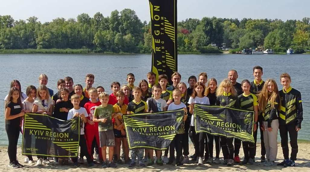 team on the background of the river